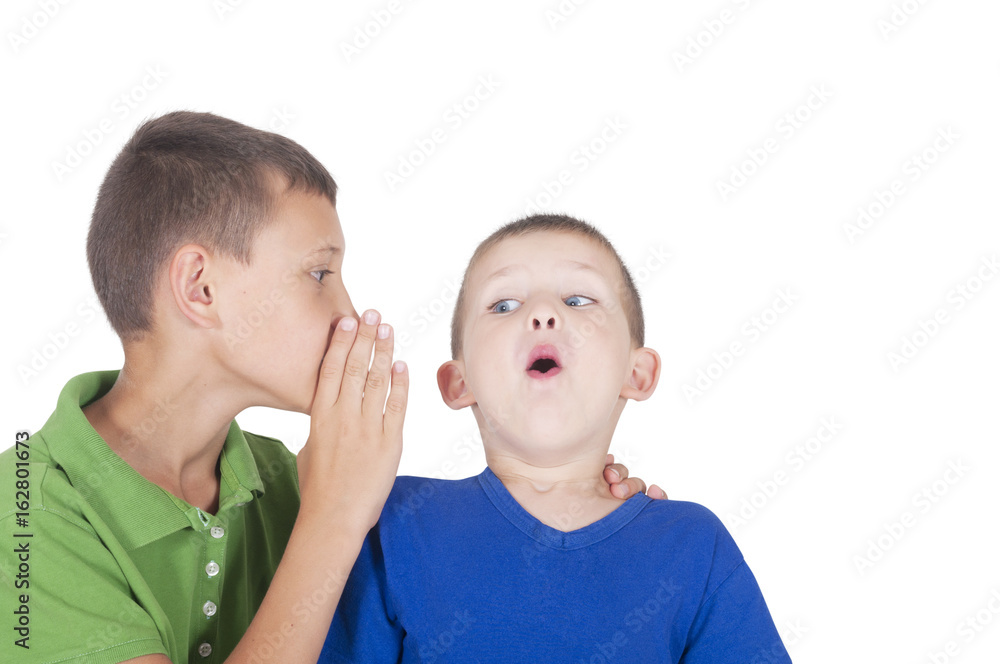 older boy tells the secret to the younger one, and he is surprised older boy tells the secret to the younger one, and he is surprised
