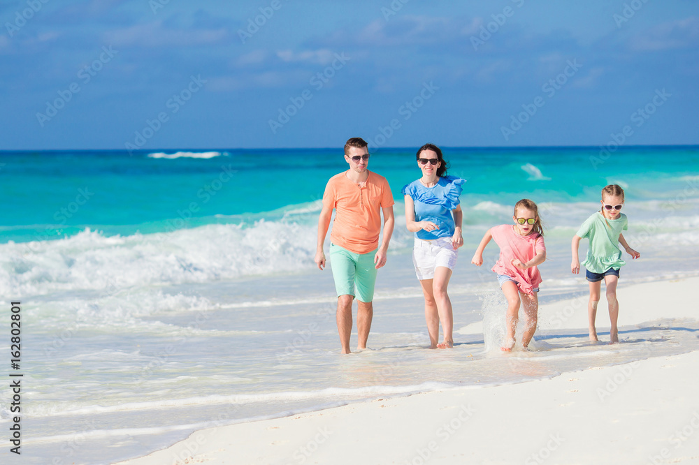 Family of four on a tropical beach