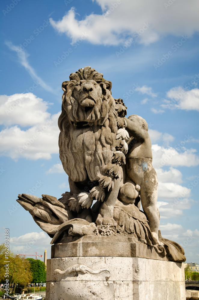 The sculpture Lion steered by a child at Alexander III bridge The sculpture Lion steered by a child at Alexander III bridge