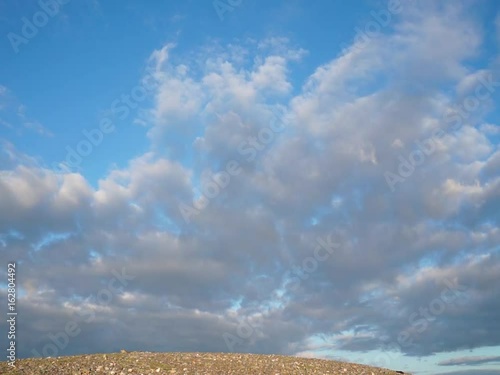Colored clouds drifting in sunset or sunrise sky, speed up footage