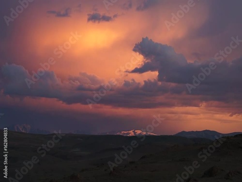 Colored clouds drifting in sunset or sunrise sky, speed up footage
