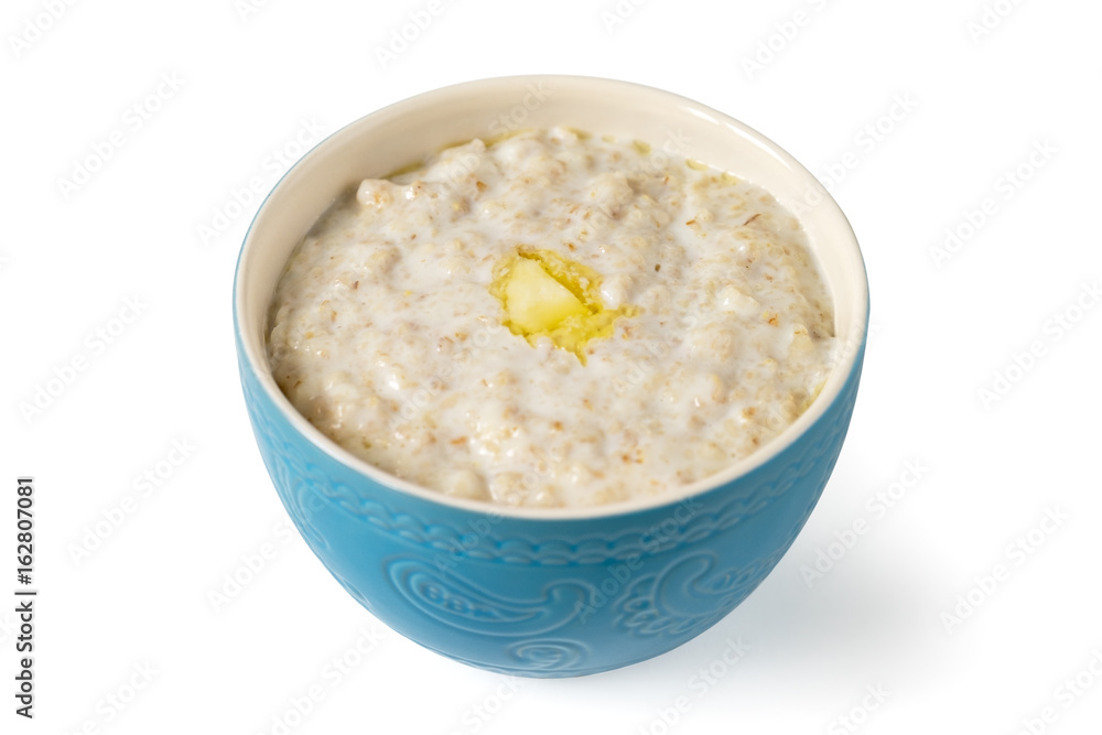 Porridge in a blue bowl with a piece of butter isolated on white background Porridge in a blue bowl with a piece of butter isolated on white background