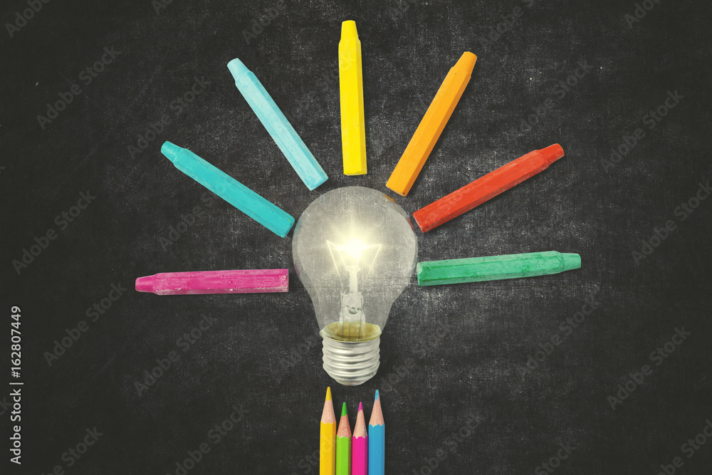 Multicolored pencils and crayons with bulb Multicolored pencils and crayons with bulb