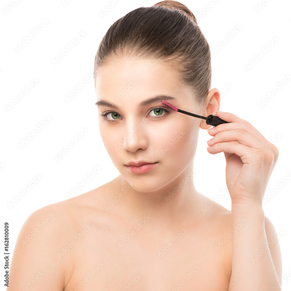 Eye make up apply. Mascara applying closeup, long lashes. Mascara brush. Portrait of beautiful young brunette woman with perfect fresh clean face skin. Eyelashes extensions. Make-up for green eyes Eye make up apply. Mascara applying closeup, long lashes. Mascara brush. Portrait of beautiful young brunette woman with perfect fresh clean face skin. Eyelashes extensions. Make-up for green eyes