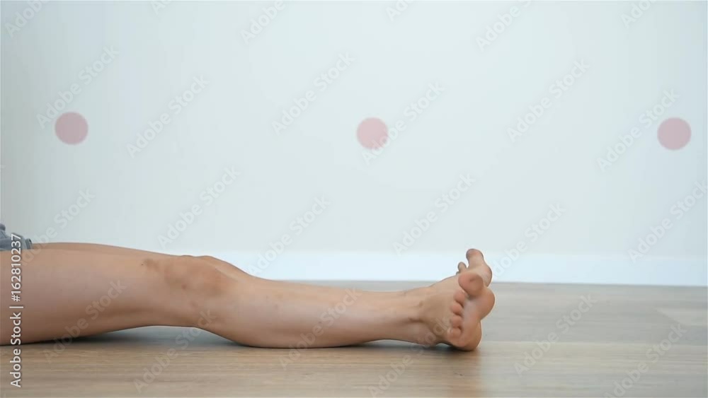 Girl Gymnast Sitting On Floor And Doing Warm Up For Legs Stock ビデオ