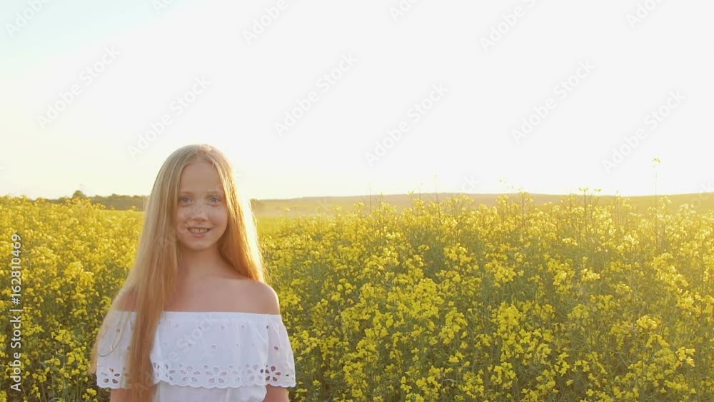 Portrait of smiling young girl looking at camera on rape's background Portrait of smiling young girl looking at camera on rape's background