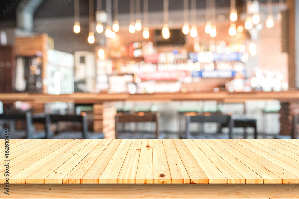 wooden table with blurred cafe background.