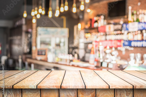 Empty wood top table with space for display product in Blurred cafe background.