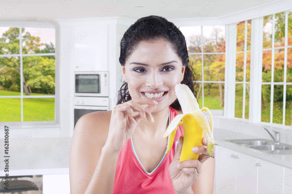 Woman peeling a banana with autumn background Woman peeling a banana with autumn background
