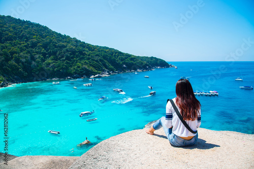 Women scenic ride Beautiful sea and blue sky at Similan island,Thailand.