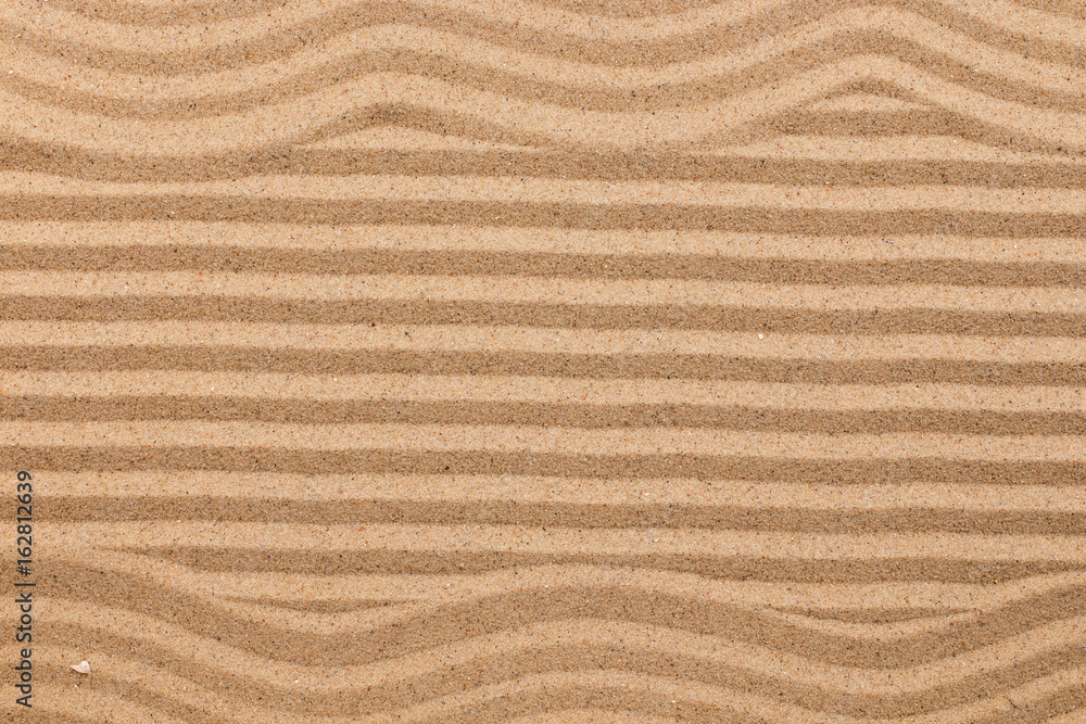 Frame made of zigzag on wavy sand.