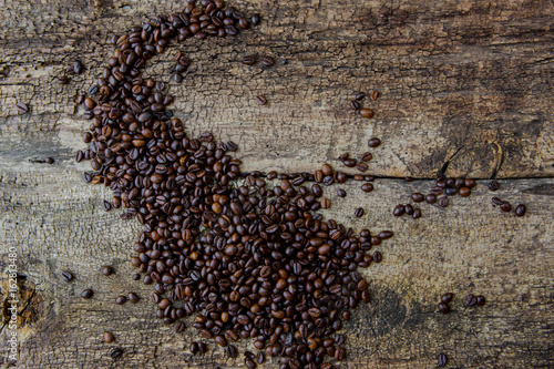 Coffee beans on wood texture background photo