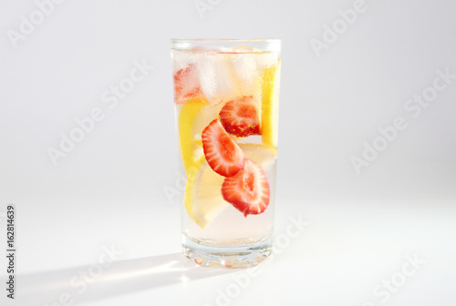 Cold cocktail with lemon and strawberries