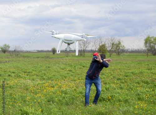 A man hides himself from a collision with a drone. Quadrocopter