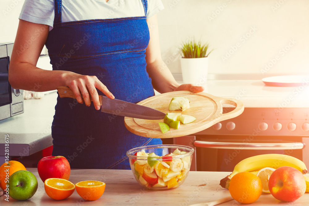 pregnant woman on kitchen making healthy fruit salad pregnant woman on kitchen making healthy fruit salad