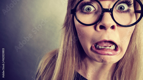 Obraz na plátně Closeup woman shocked face with eyeglasses