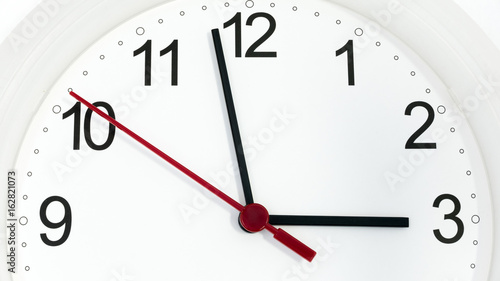 Closeup clock ticking showing three hours
