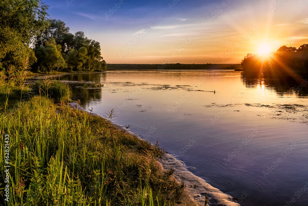 Sunset over the Dnieper river in Kiev, Ukraine, during a warm summer evening. Sunset over the Dnieper river in Kiev, Ukraine, during a warm summer evening.