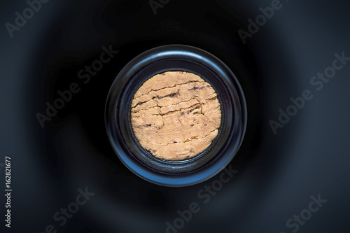 cork in the wine bottle and blurry background, photographed from above for winemaker business card or book cover