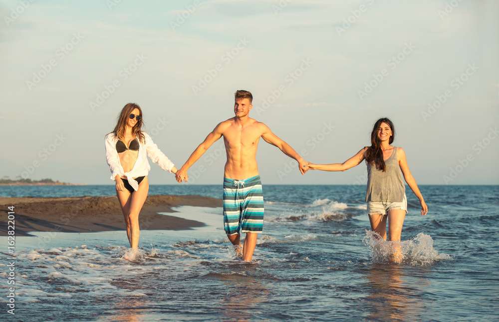 Group of friends together on the beach having fun.