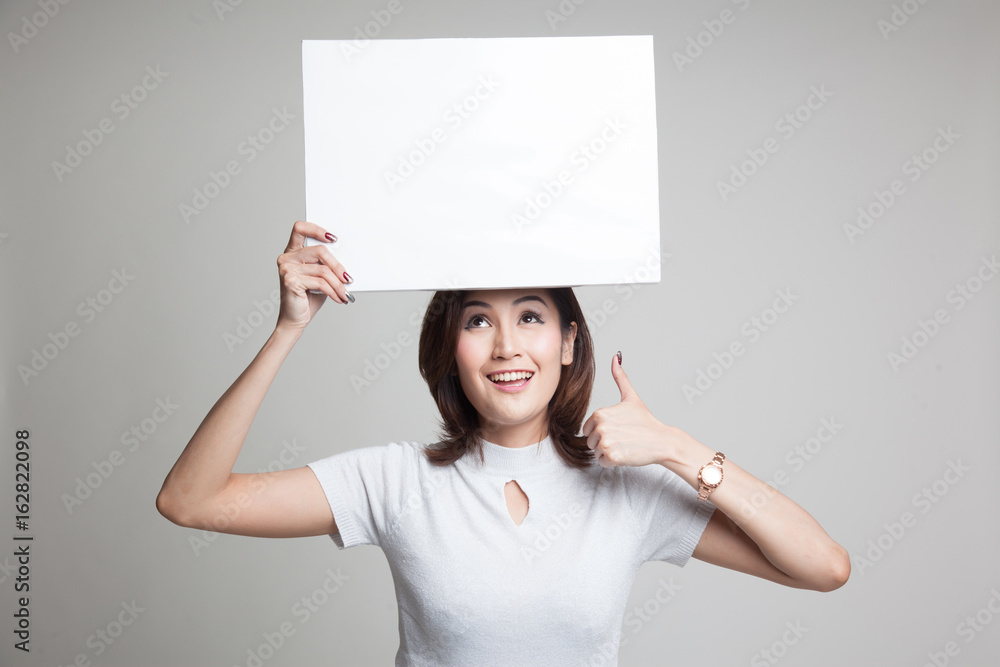 Young Asian woman show thumbs up with white blank sign. Young Asian woman show thumbs up with white blank sign.