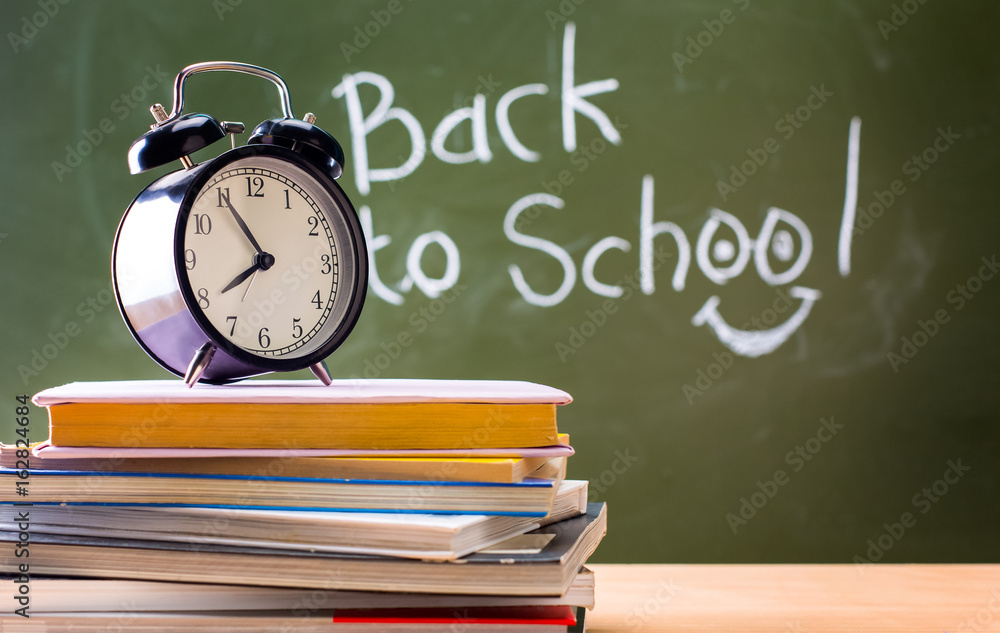 The blackboard is written Back to school. Books and clocks. Conc The blackboard is written Back to school. Books and clocks. Conc