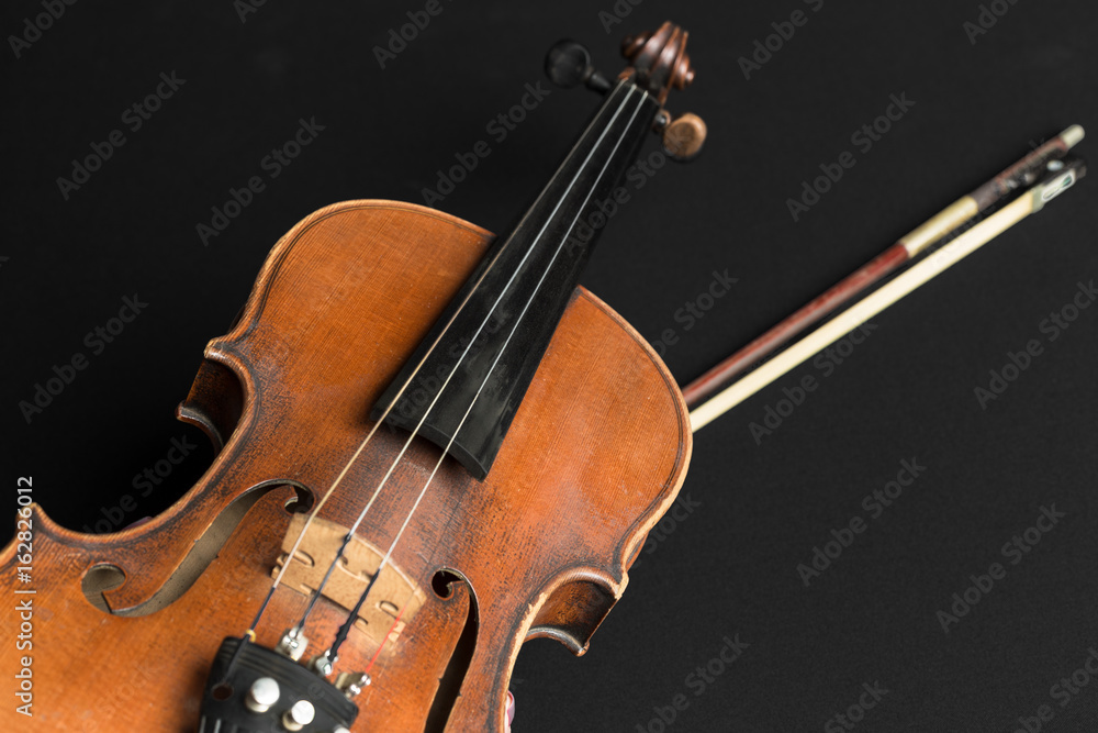 Fototapeta premium Old violin on a black background