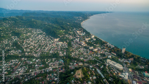 Landscape with night city of Sukhum Abkhazia from a height on a background of calm sea © vvicca