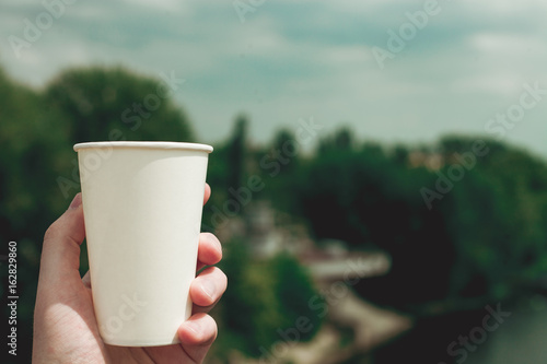 Paper cup on a background of urban landscapes