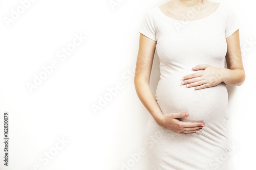 Canvas Print Young, pregnant woman on white background