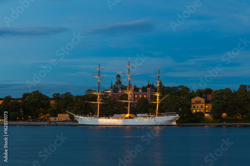 Stockholm night vew. Illuminated boats along city embankment. photo