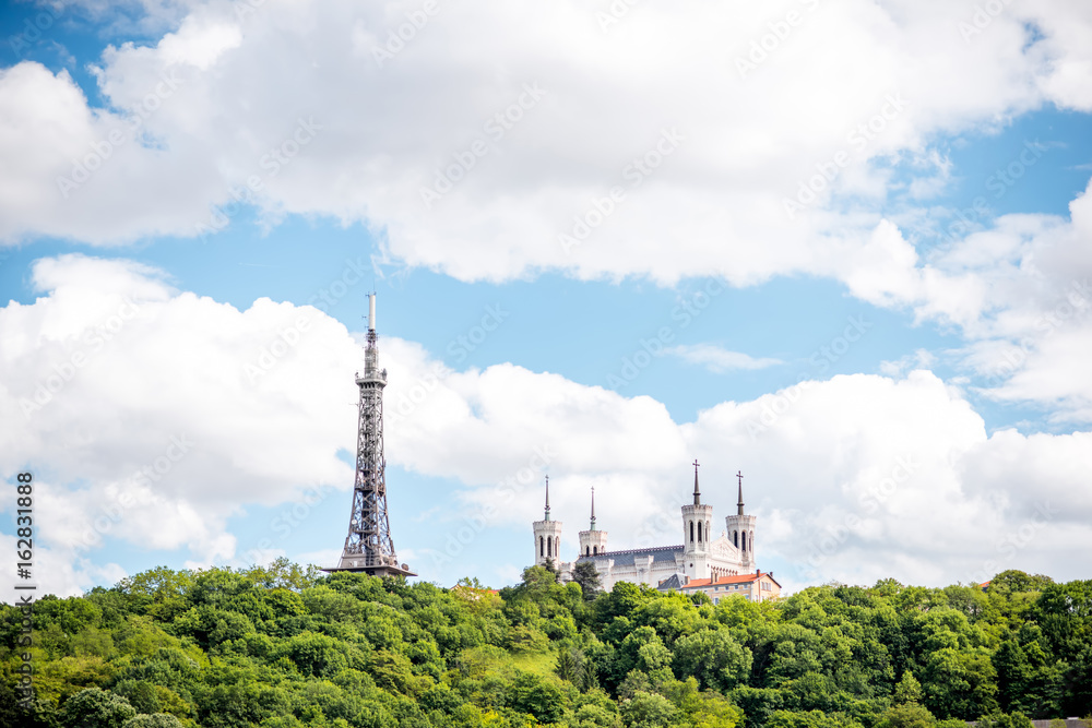 Obraz premium View on the mountain with Notre-Dame cathedral and metallic tower in Lyon city in France