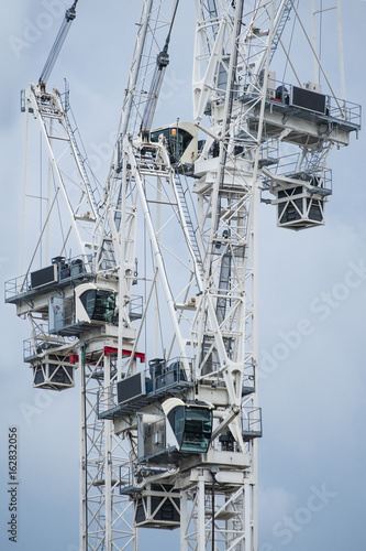 Three construction cranes