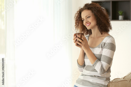 Young woman with cup of aro...