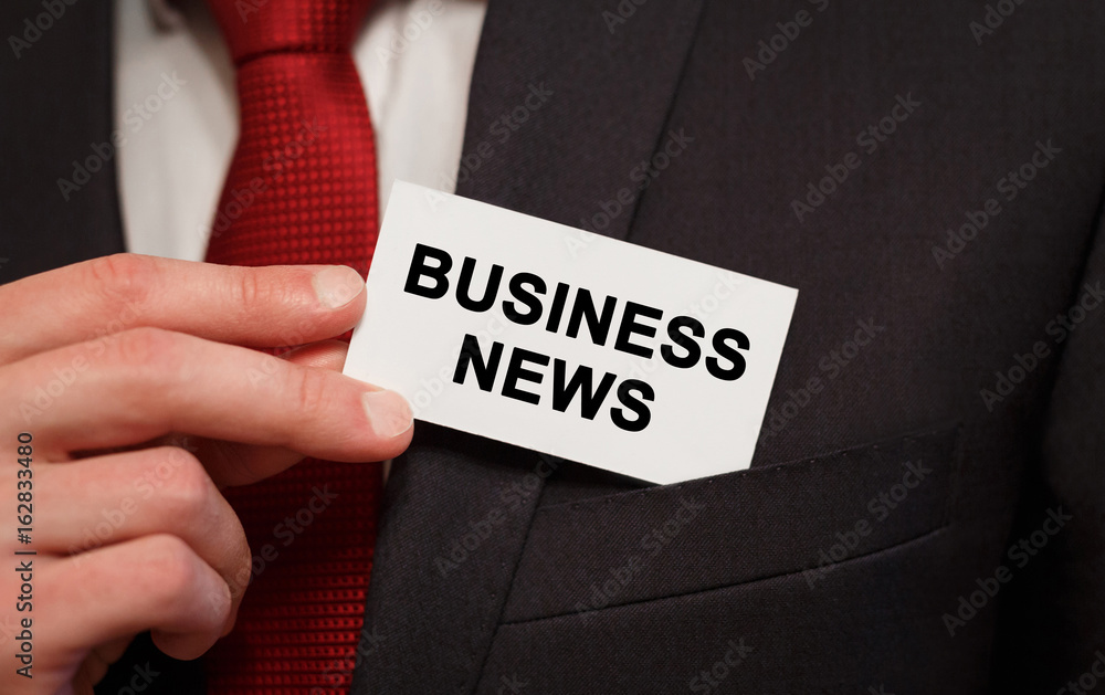 Businessman putting a card with text Business News in the pocket Businessman putting a card with text Business News in the pocket