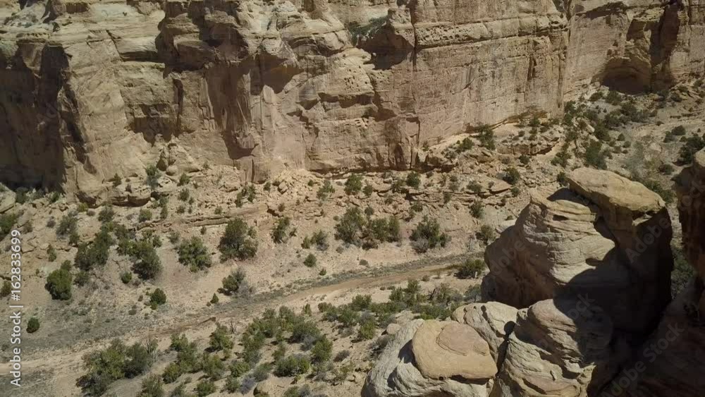 Aerial Eagle Arch San Rafael Utah pull out desert land. Geologic desert landscape. Valleys, canyons, gorges and mesa. Nature wilderness for exploring, hiking and off road recreation. Dry remote desert