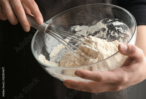 Photos Human hands stirring dough with flour in glass bowl