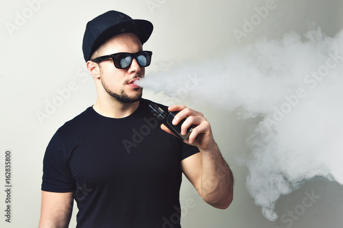 Vaping man and a cloud of vapor
