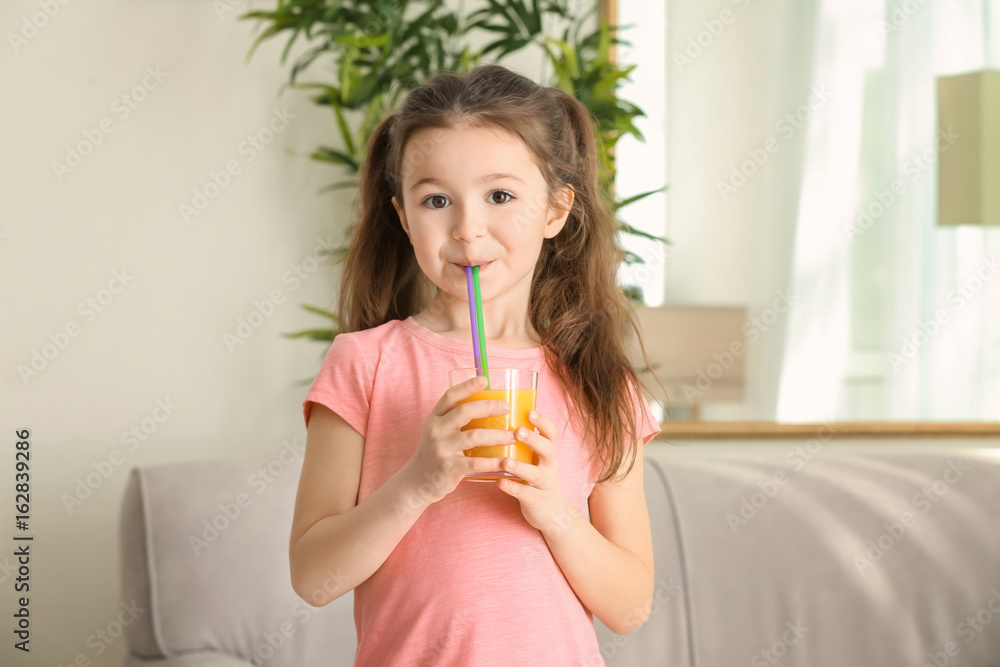 Cute little girl drinking juice at home Cute little girl drinking juice at home