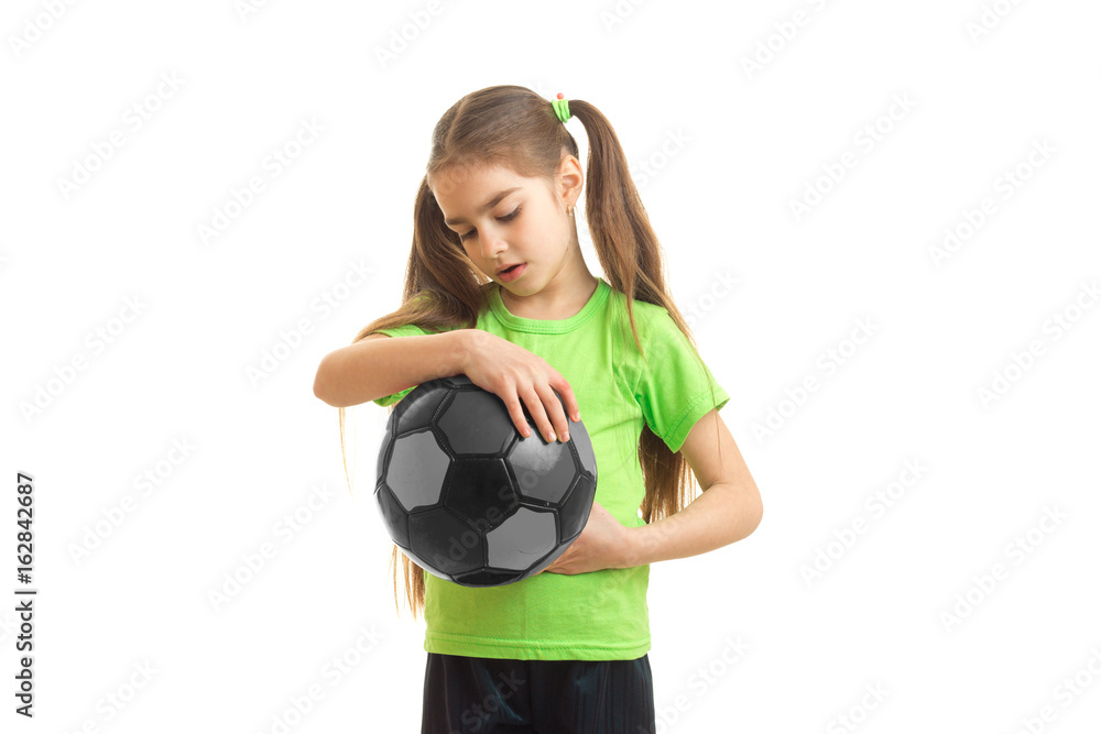 young little girl in green shirt with soccer ball in hands young little girl in green shirt with soccer ball in hands