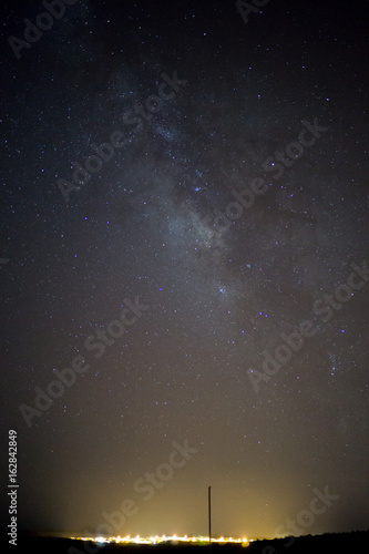 Εκτύπωση καμβά milkyway over a village in the desert - is there anybody out there?