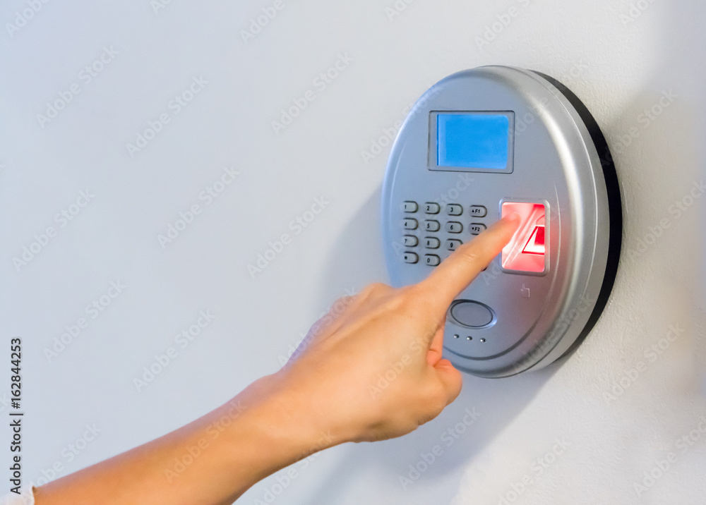 woman hand using silver biometric scan with red fingerprint sensor woman hand using silver biometric scan with red fingerprint sensor