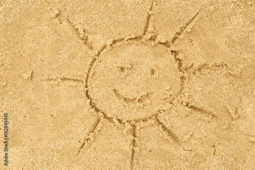 sun drawing in sand