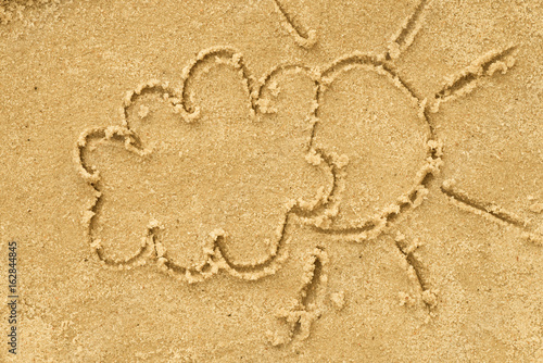 cloud and sun drawing in sand