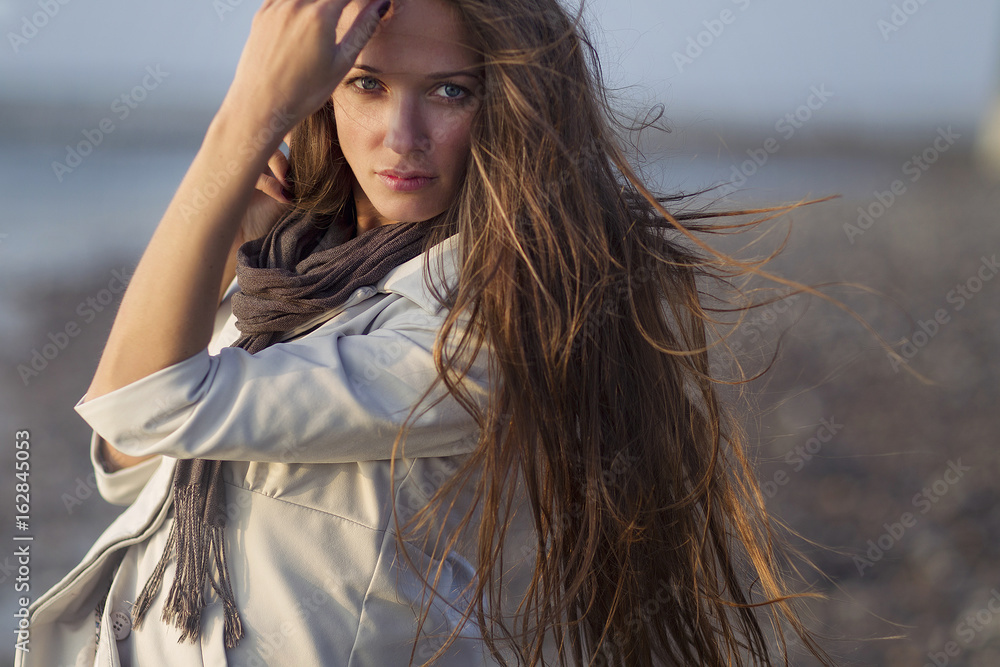 Portrait of a girl, model on a windy day by the sea. Portrait, beauty, tenderness. Portrait of a girl, model on a windy day by the sea. Portrait, beauty, tenderness.
