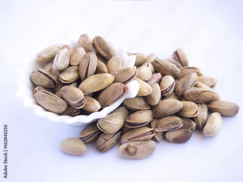 Pistachio nuts isolated in plates