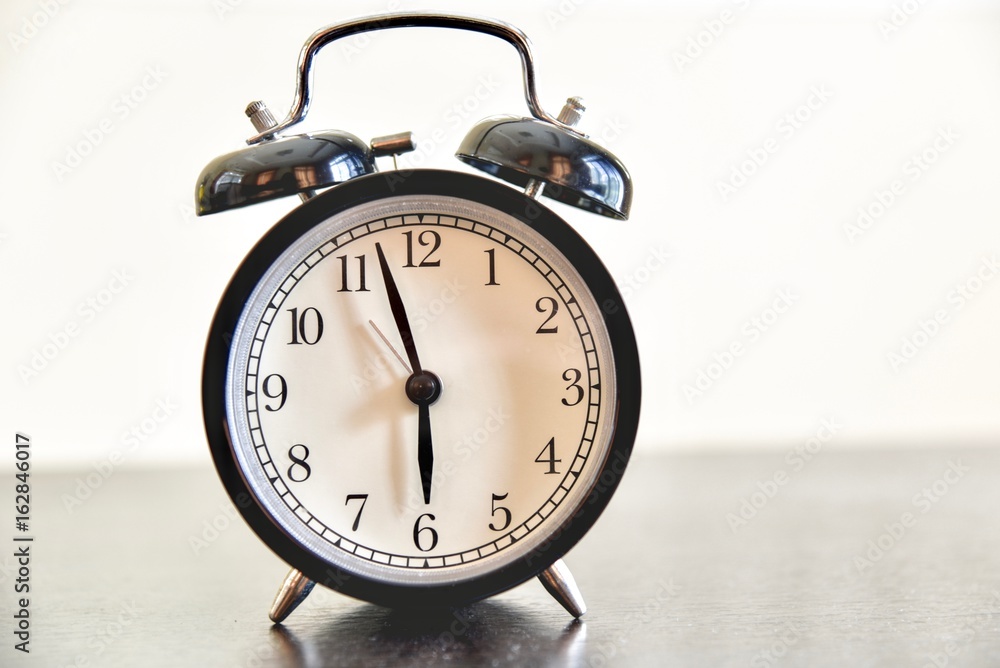 Morning Alarm Clock Isolated on a Wooden Table Morning Alarm Clock Isolated on a Wooden Table