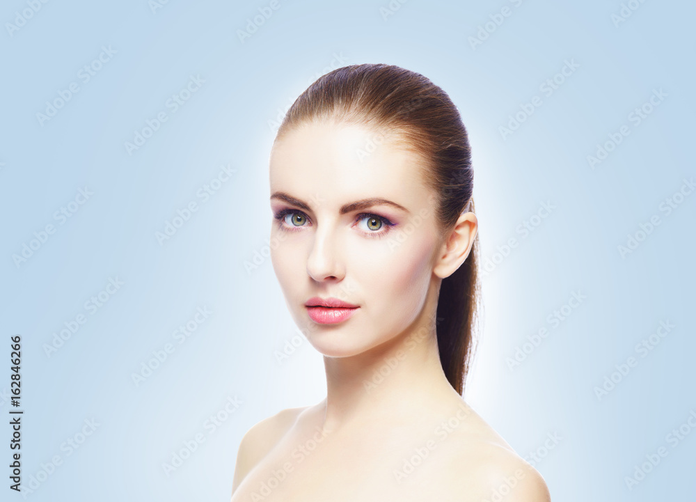 Portrait of young, beautiful and healthy woman: over blue background. Healthcare, spa, makeup and face lifting concept. Portrait of young, beautiful and healthy woman: over blue background. Healthcare, spa, makeup and face lifting concept.