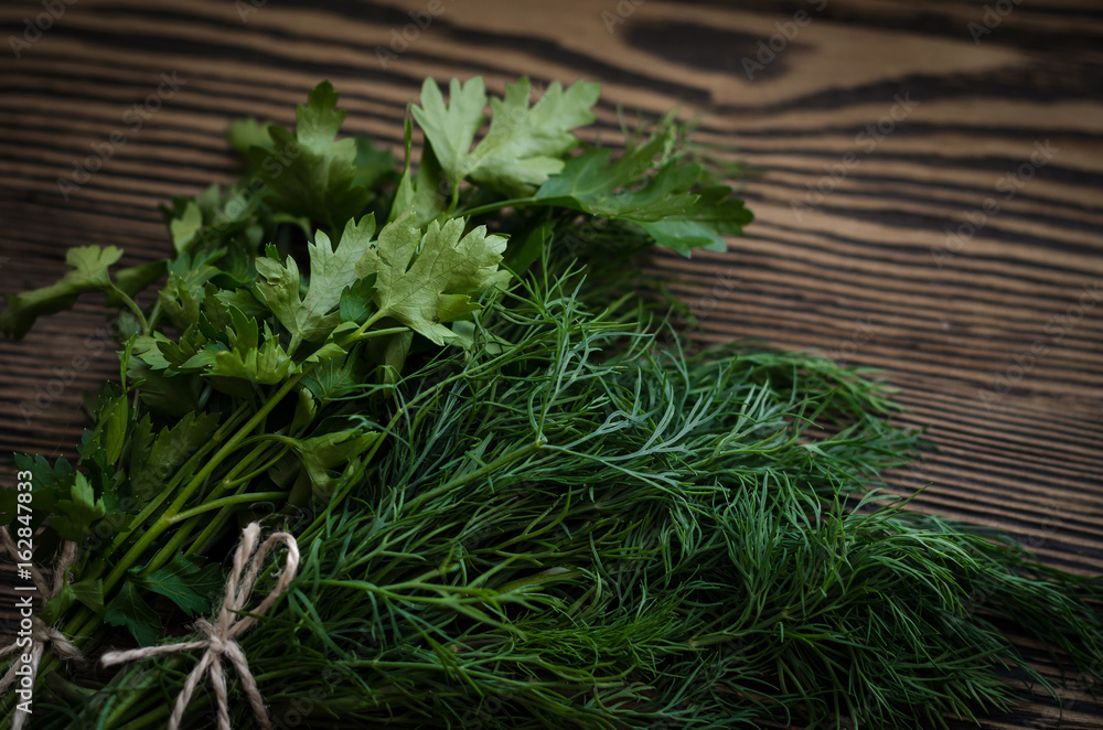 Fresh green dill and parsley herbs on rustic wooden table. Top view with copy space Fresh green dill and parsley herbs on rustic wooden table. Top view with copy space