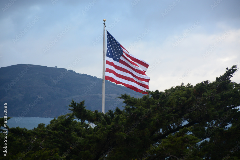 View of American flag near Coit tower in San Francisco, California